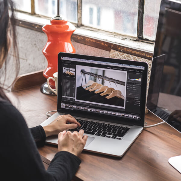 woman-edits-images-on-her-laptop